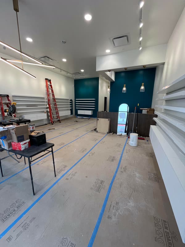 Framing, walls and the teal feature wall taking shape inside the office later in the build